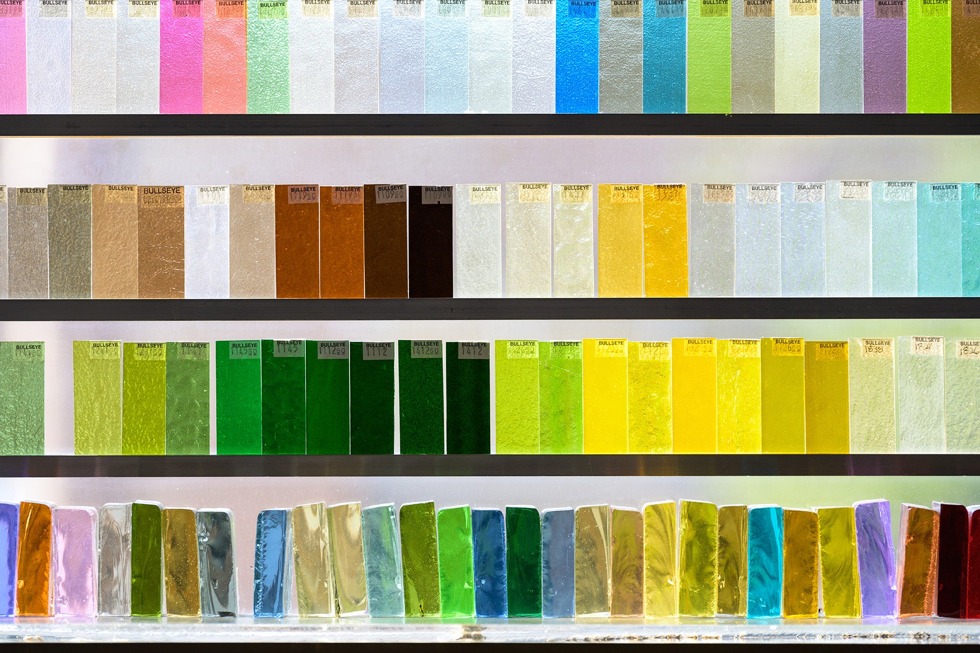 Glass samples in a window with various colors arranged in rows.