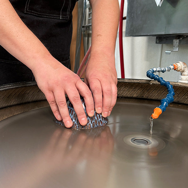 A bowl being shaped on a lap wheel