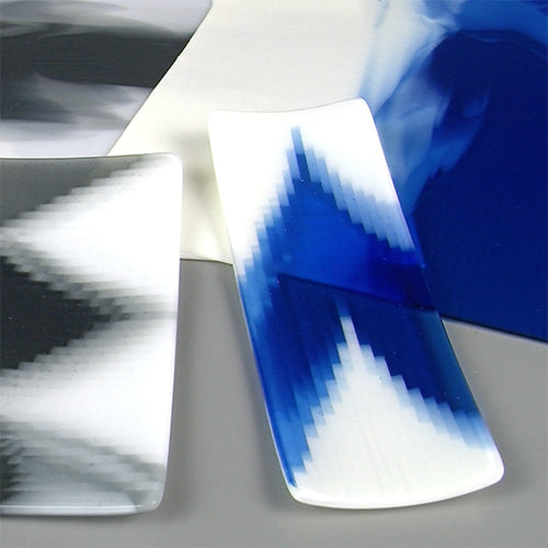 Glass plates with blue and white abstract pattern on a gray background